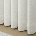 Beige White Liz Linen Pleated Curtains rounded curtain hems above a pale wood floor