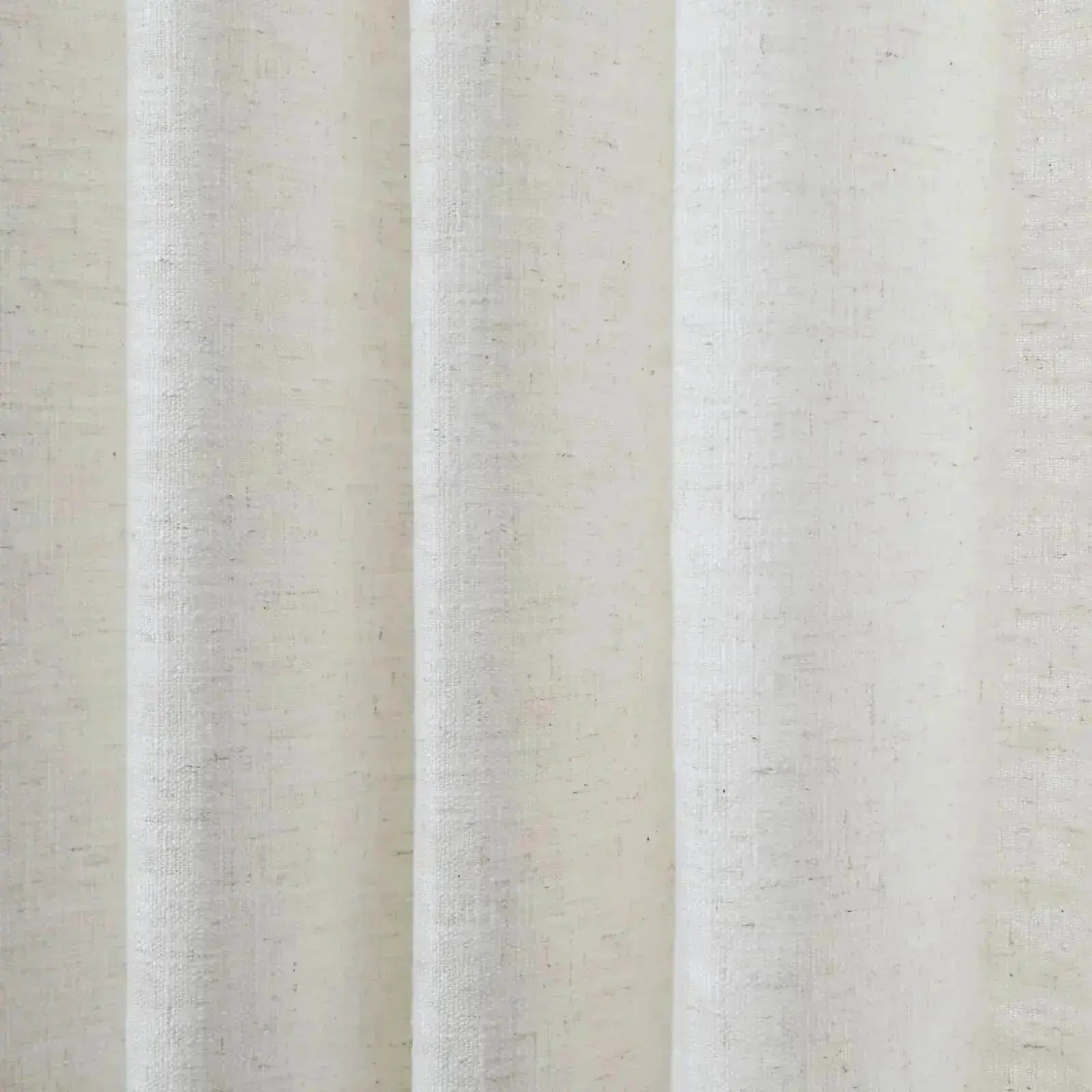 Textile photograph of off-white pleated fabric with a visible natural linen-like weave and subtle dark flecks