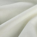 Textile close-up of off-white woven fabric with visible texture, soft drapes, and subtle highlights and shadows
