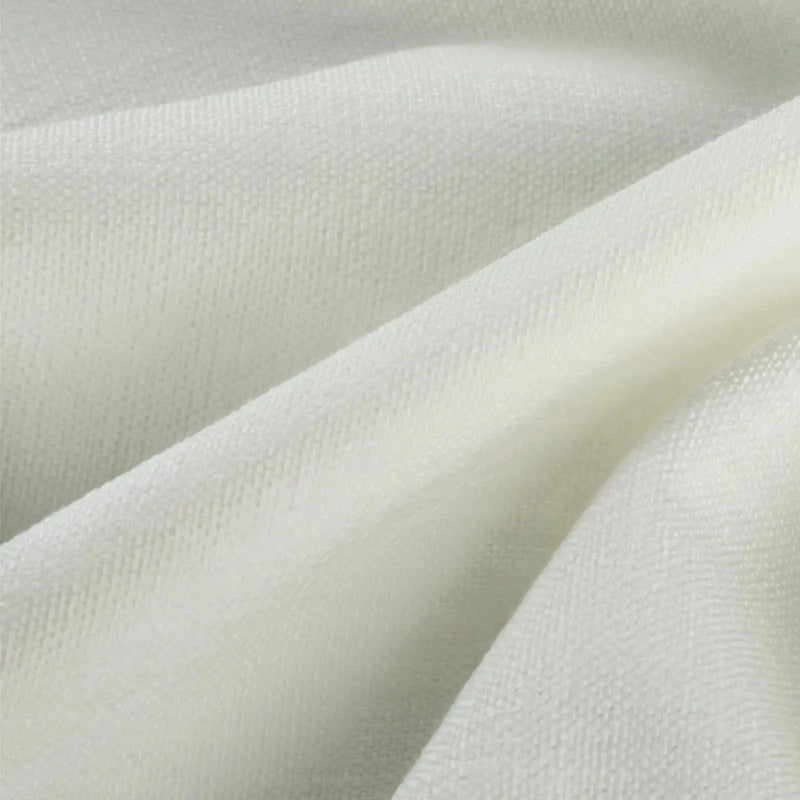 Textile close-up of off-white woven fabric with visible texture, soft drapes, and subtle highlights and shadows