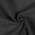 Textile image featuring a close-up of deep black fabric with a distinctive granular texture and soft, organic folds creating subtle shadows