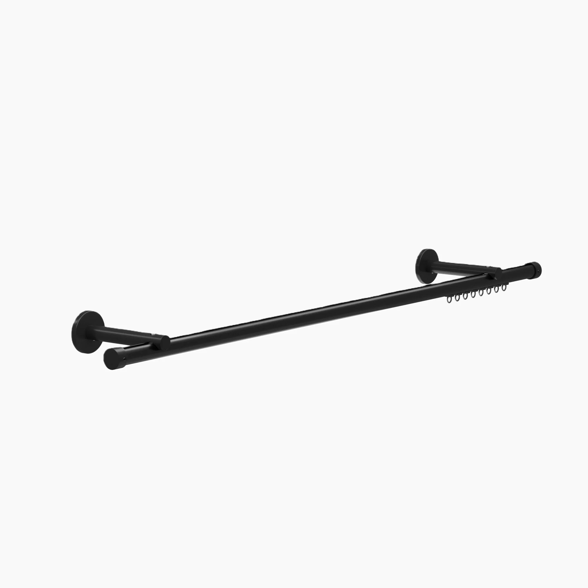 Matte black double curtain pole with circular wall mounts, decorative end caps, and curtain rings visible on the back pole