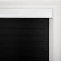 Black horizontal fabric window Blinds featuring a white headrail and decorative white trim around the frame with a visible white pull cord on the right side