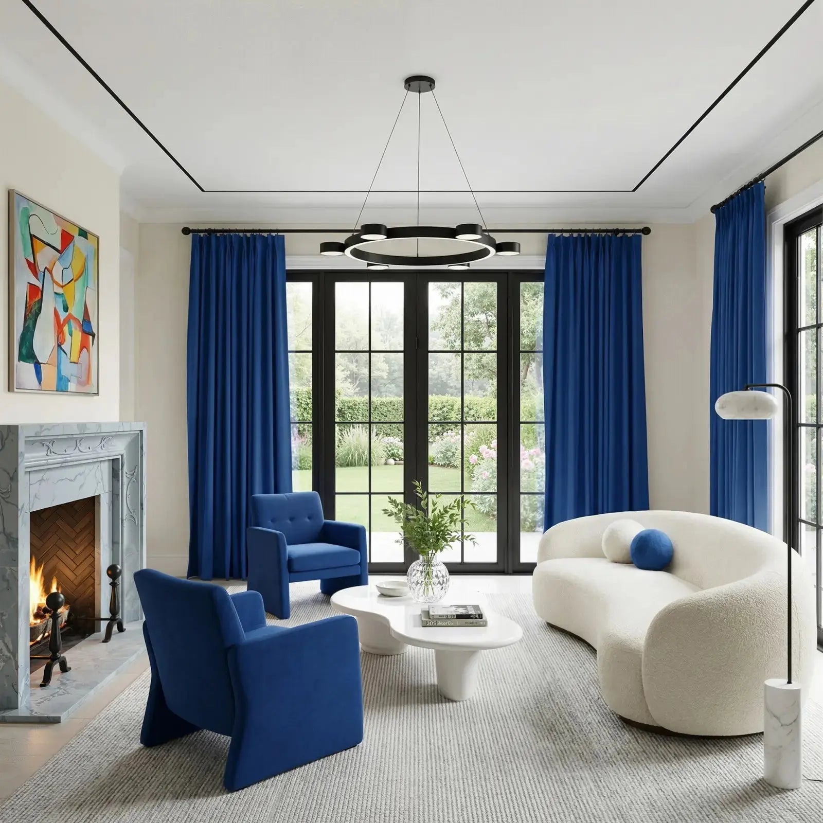 A bright modern living room showcases vibrant royal blue curtains and armchairs, a curved off-white boucle sofa, an abstract colorful painting over a lit marble fireplace, and black French doors opening to a lush garden