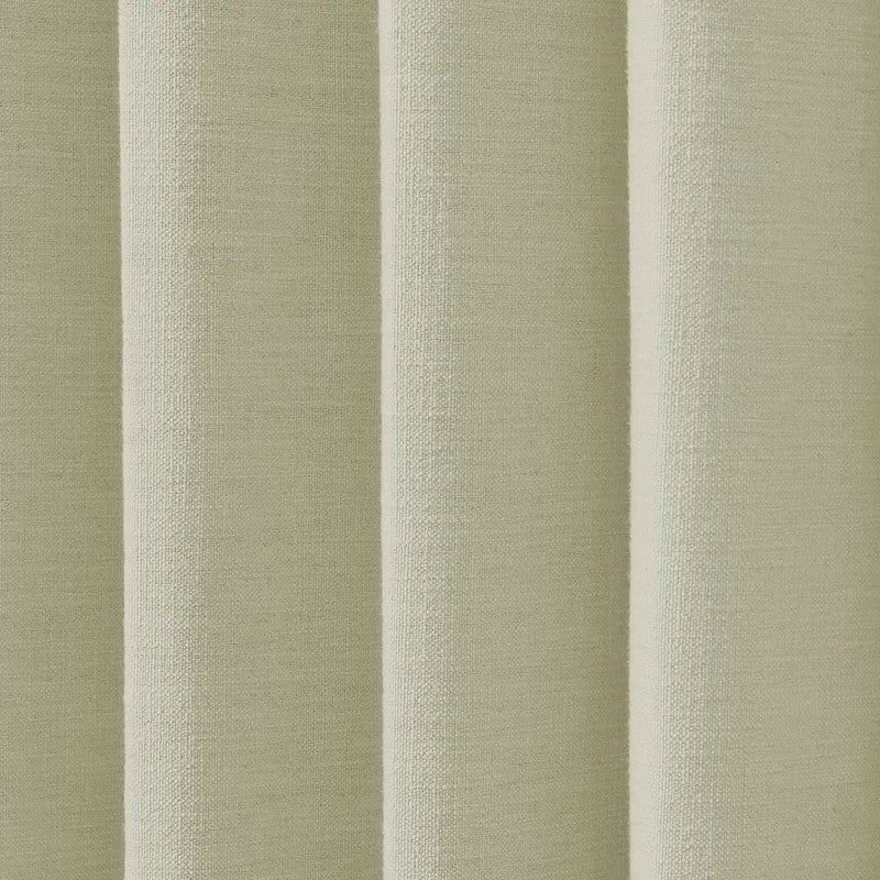 Textile of a pale sage green fabric with distinct vertical folds and a prominent nubbly woven texture