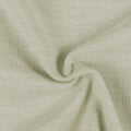 Photograph of a muted sage green fabric with a loosely woven textured surface and soft folds forming a central swirl