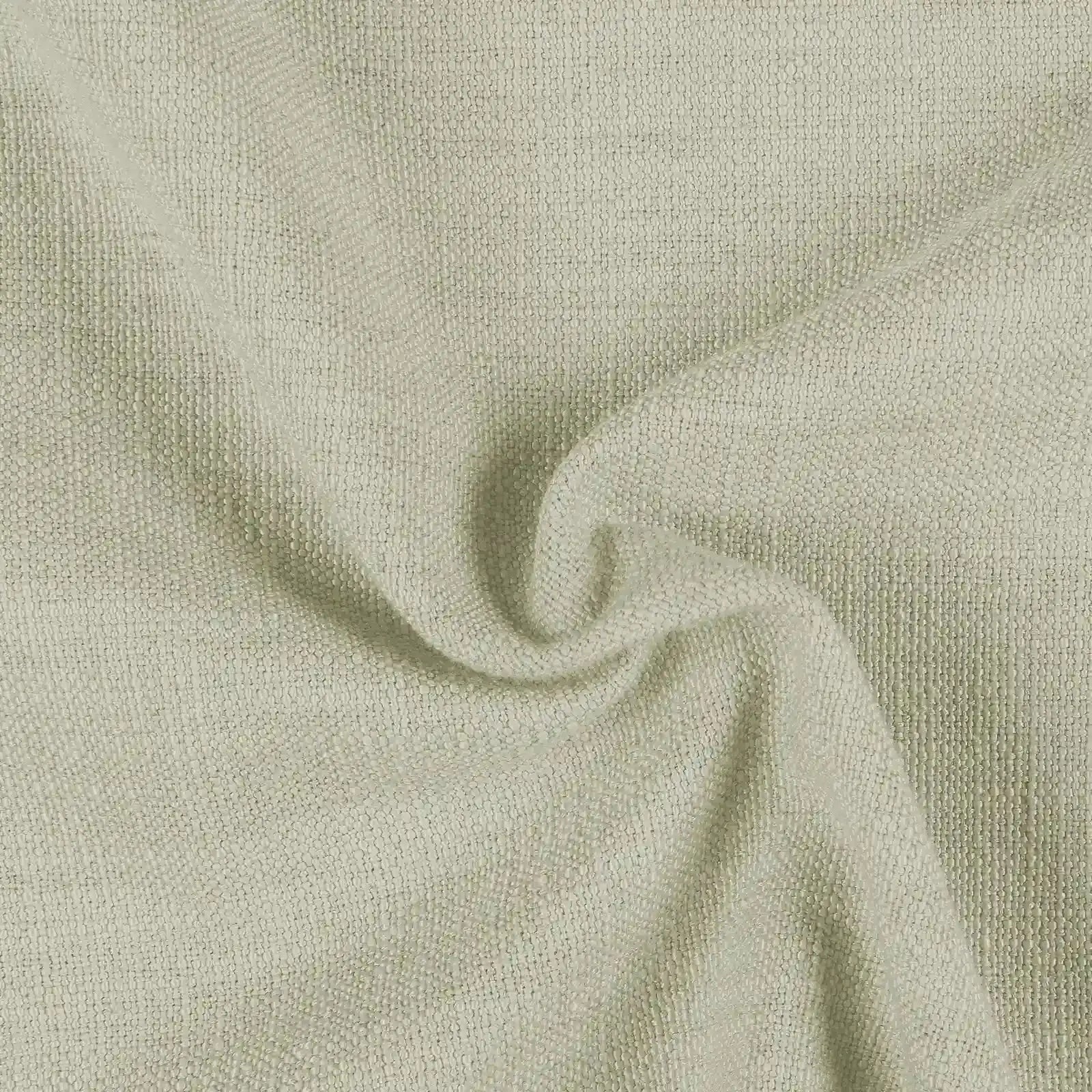 Photograph of a muted sage green fabric with a loosely woven textured surface and soft folds forming a central swirl
