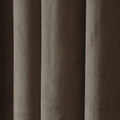 Close-up of pleated taupe velvet fabric showcasing its soft texture and dynamic light and shadow across vertical folds