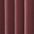 A close-up of textured reddish-brown woven fabric with prominent vertical folds creating shadows and highlights