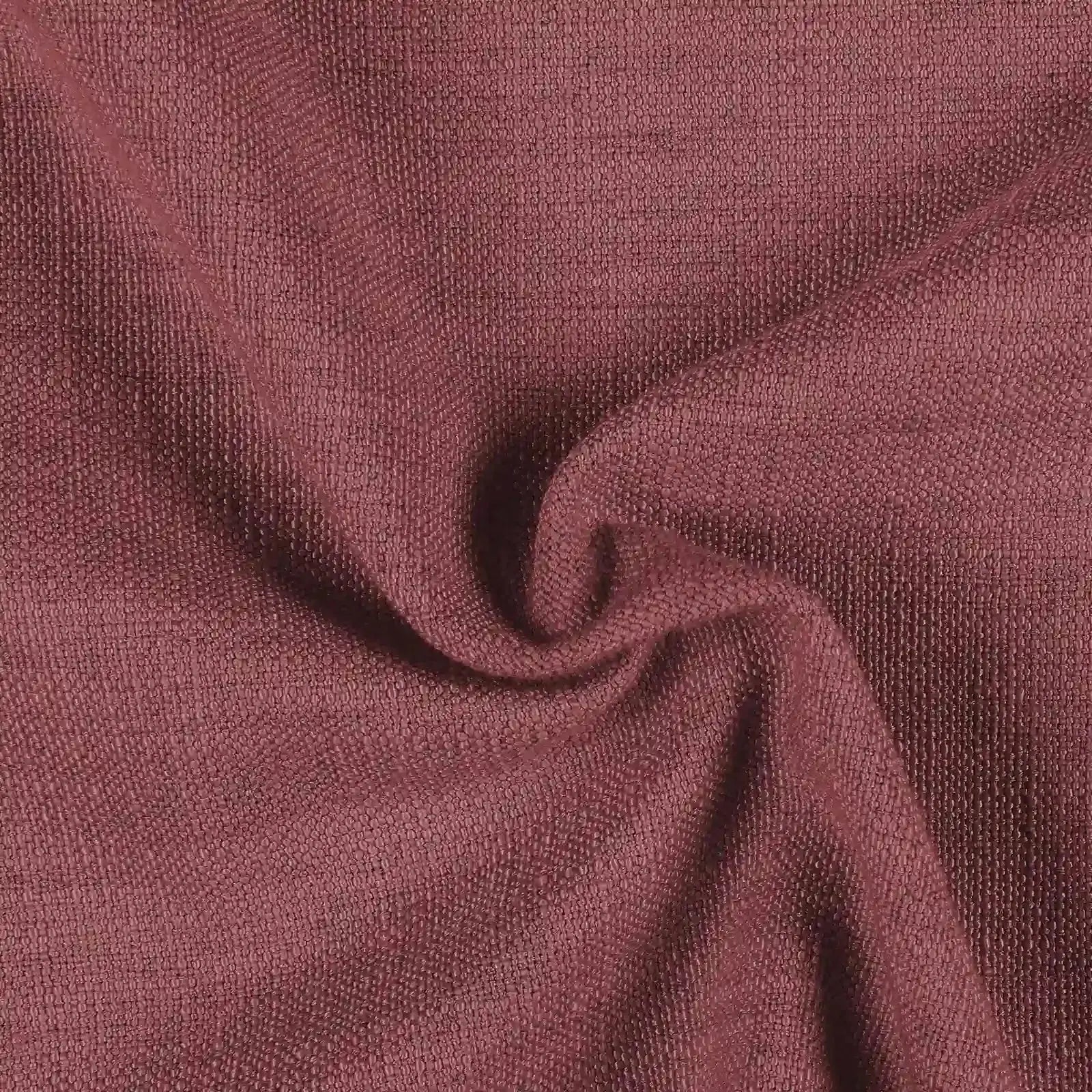 Photograph of a deep dusty rose woven fabric featuring a fine textured surface, soft undulating drapes, and rich tonal shadows