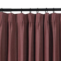 Product photo of a pleated mulberry textured curtain panel hanging from a black rod with rings