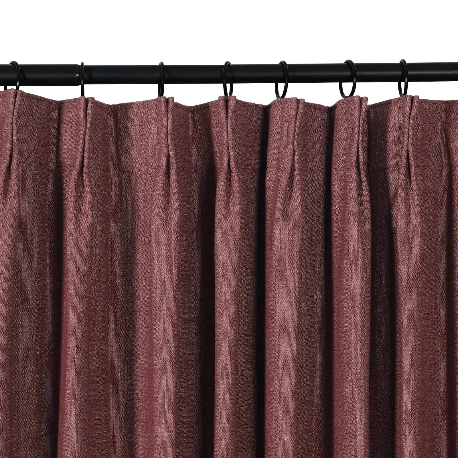 Product photo of a pleated mulberry textured curtain panel hanging from a black rod with rings