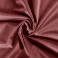 Photograph of deep maroon velvet fabric elegantly swirled into soft, textured folds capturing a luxurious sheen