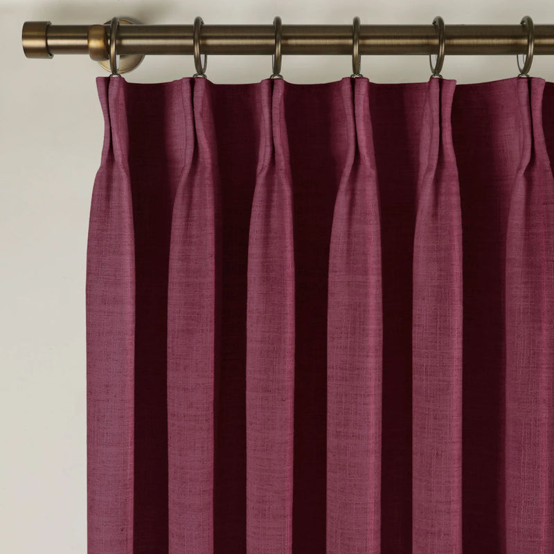 Burgundy Red Liz linen curtains viewed at an angle in a softly styled room with natural daylight