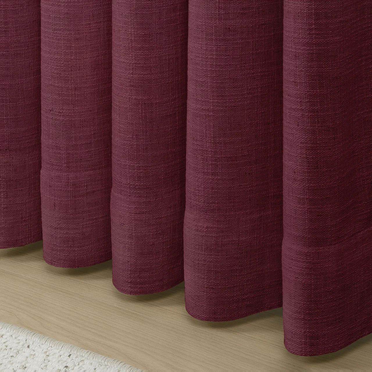 Burgundy Red Liz linen curtains showing the lower drape and pooling folds near the floor