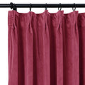 Deep magenta velvet pinch pleat curtain hanging from a black metal rod with rings