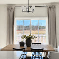 Burlywood Birch Liz Linen Pleated Curtains framing sliding patio doors behind a dark wood dining table