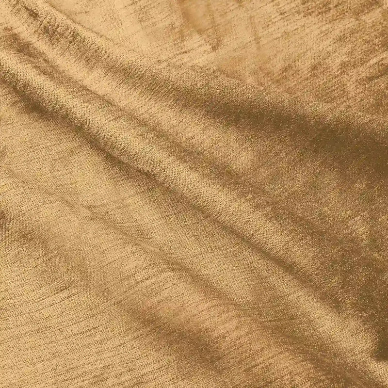 Textured warm golden brown fabric softly draped with crinkled folds highlighting its subtle shimmer and woven thread details