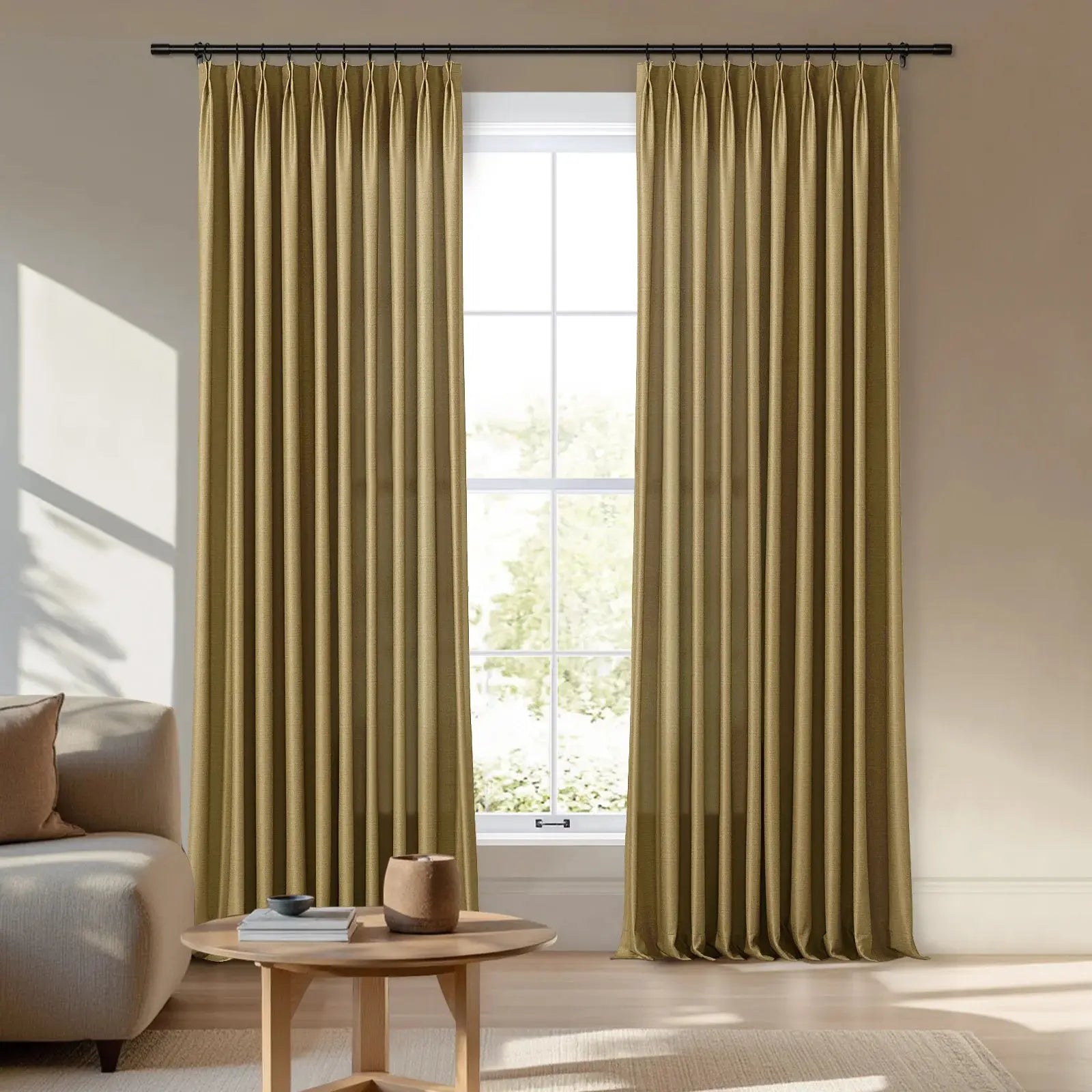 Photography of pleated olive gold curtains on a black rod framing a four-pane window in a bright modern living room featuring a cream sofa and a round wooden coffee table casting sunlit shadows