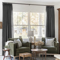Carbon Grey Liz linen curtains framing a bright window in a balanced full-length interior view