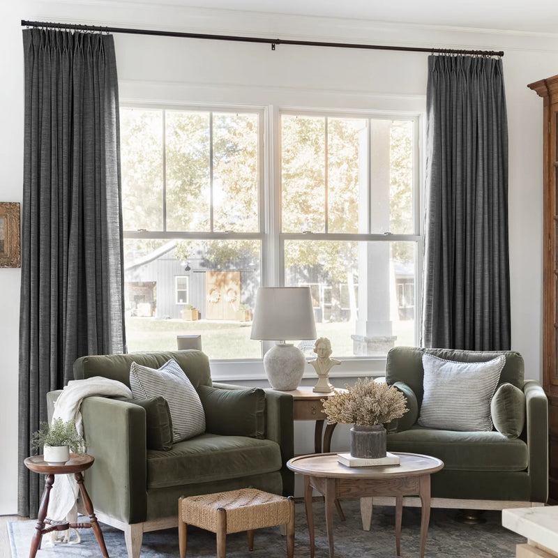 Carbon Grey Liz linen curtains framing a bright window in a balanced full-length interior view