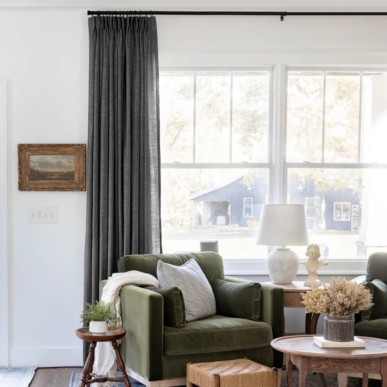 Carbon Grey Liz linen curtains shown closer beside a sunlit window with smooth vertical folds