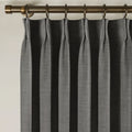 Carbon Grey Liz linen curtains viewed at an angle in a softly styled room with natural daylight