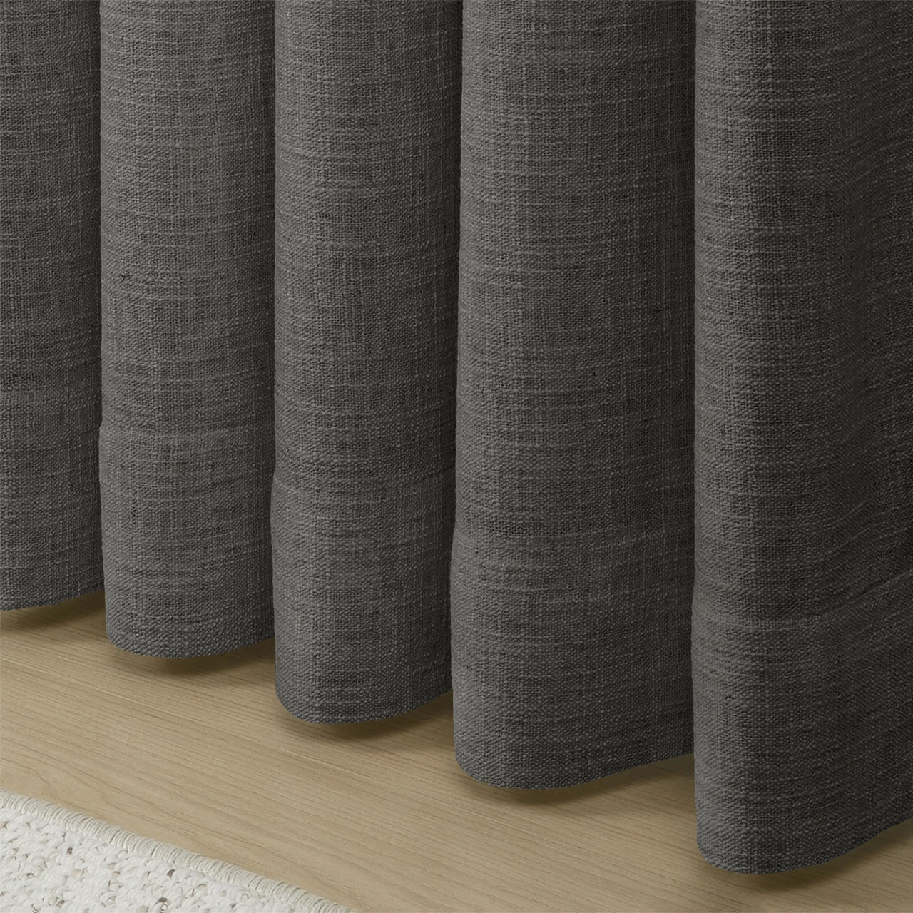 Carbon Grey Liz linen curtains showing the lower drape and pooling folds near the floor