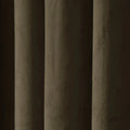 A close-up of a dark brown textured curtain featuring deep vertical folds, a velvety fabric surface, and muted olive-green and dark brown tones highlighted by soft light