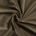 Photograph of draped muted olive-brown velvet fabric with a plush texture forming a central spiral swirl and soft folds highlighted by light and shadow