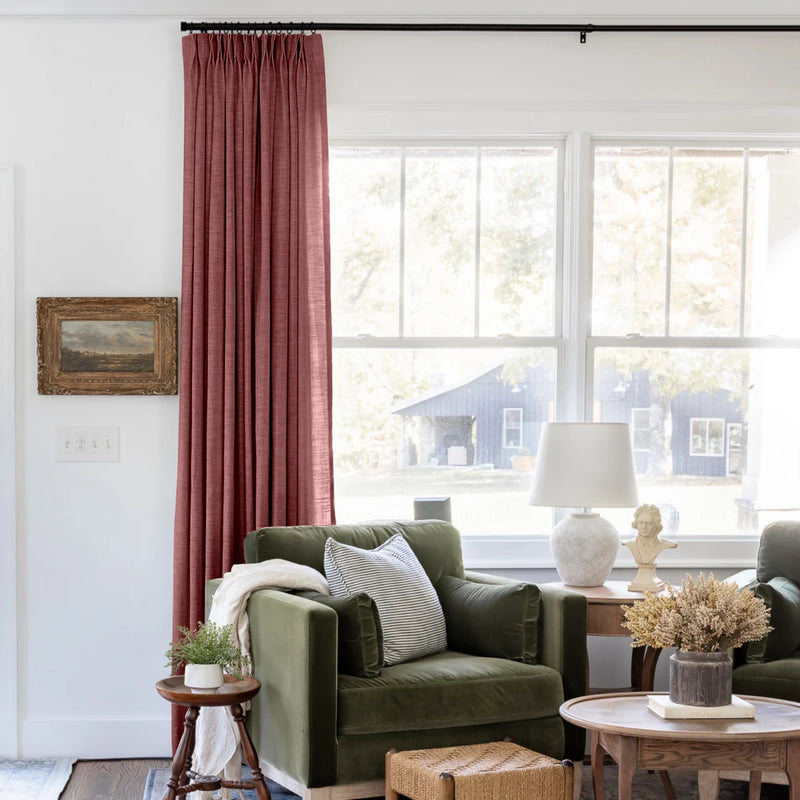 Cinnabar Liz linen curtains shown closer beside a sunlit window with smooth vertical folds