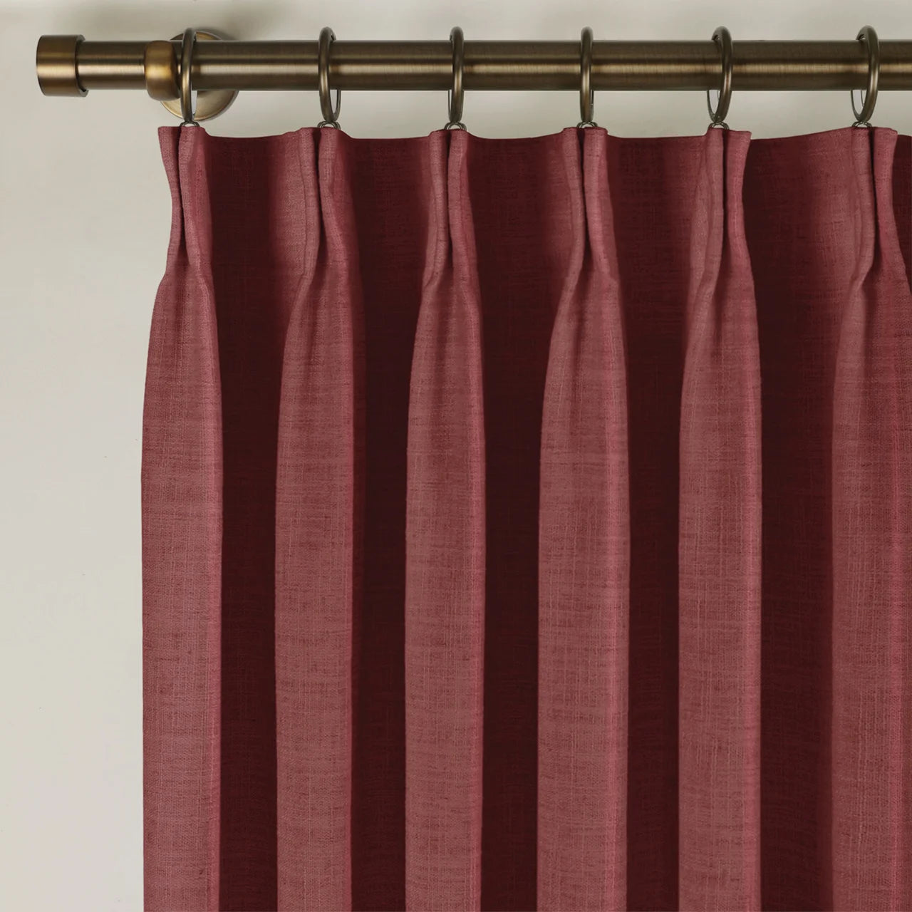 Cinnabar Liz linen curtains viewed at an angle in a softly styled room with natural daylight