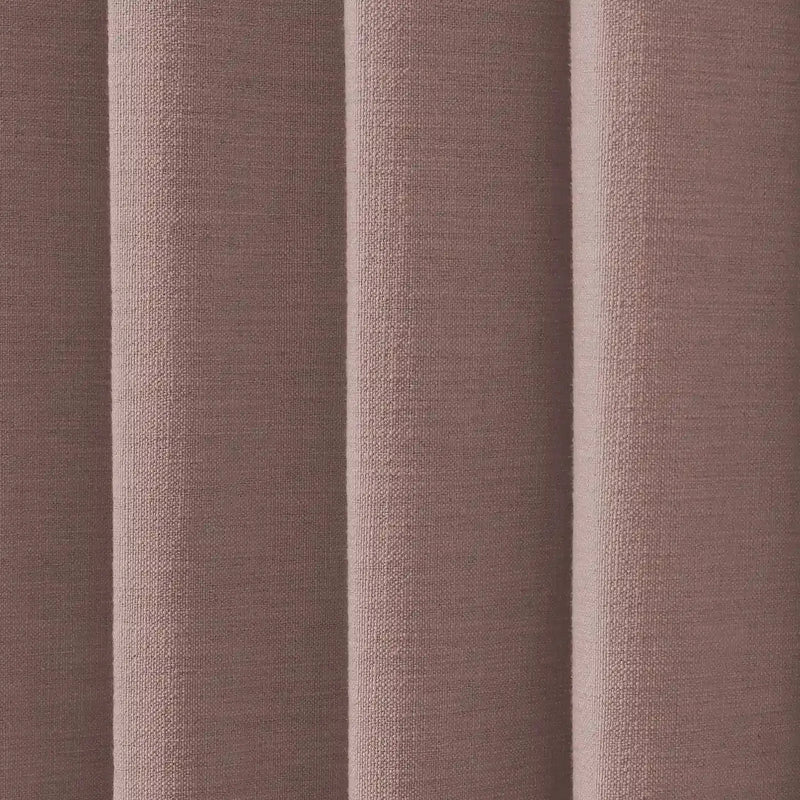Photograph of woven fabric in a muted dusty rose or brownish-pink hue displaying soft vertical pleats with visible texture and subtle shadows
