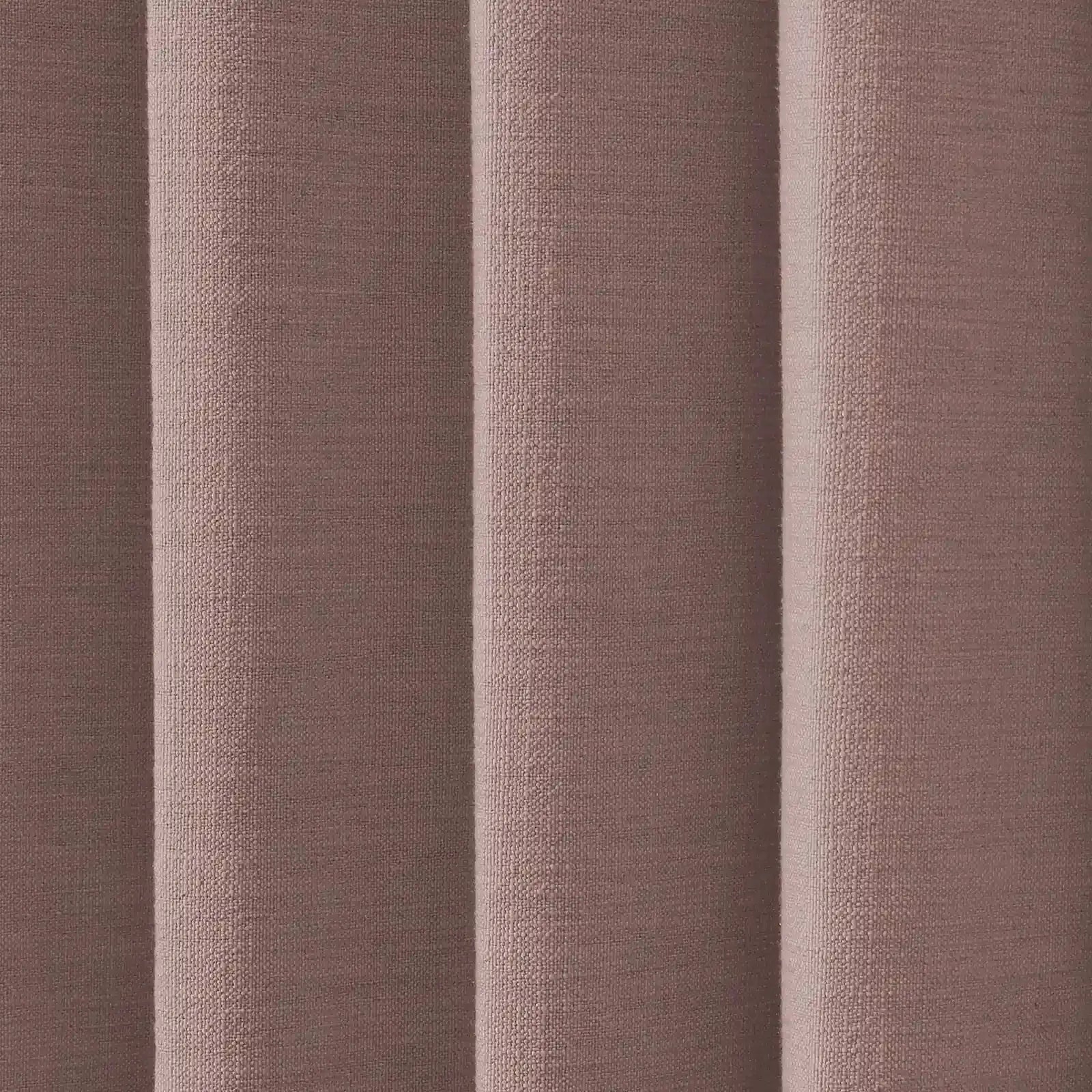 Photograph of woven fabric in a muted dusty rose or brownish-pink hue displaying soft vertical pleats with visible texture and subtle shadows