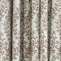Woven fabric curtain with a light cream base and vertical pleats adorned with a repeating reddish-brown botanical leaf design