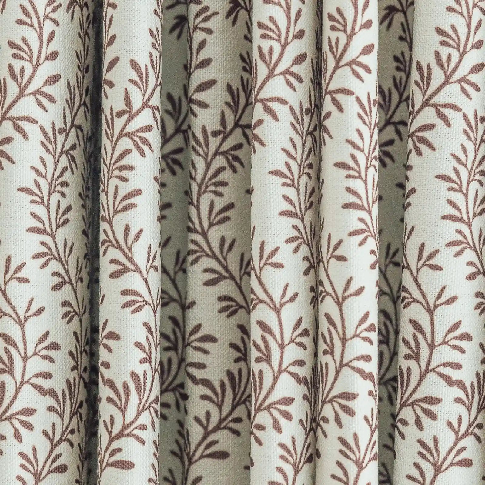 Woven fabric curtain with a light cream base and vertical pleats adorned with a repeating reddish-brown botanical leaf design