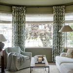 Britt Bengoechea x TWOPAGES Cottage Floral Printed Linen Cotton Pleated Curtains - Cypress floral curtains wrapping an olive-green bay-window living room