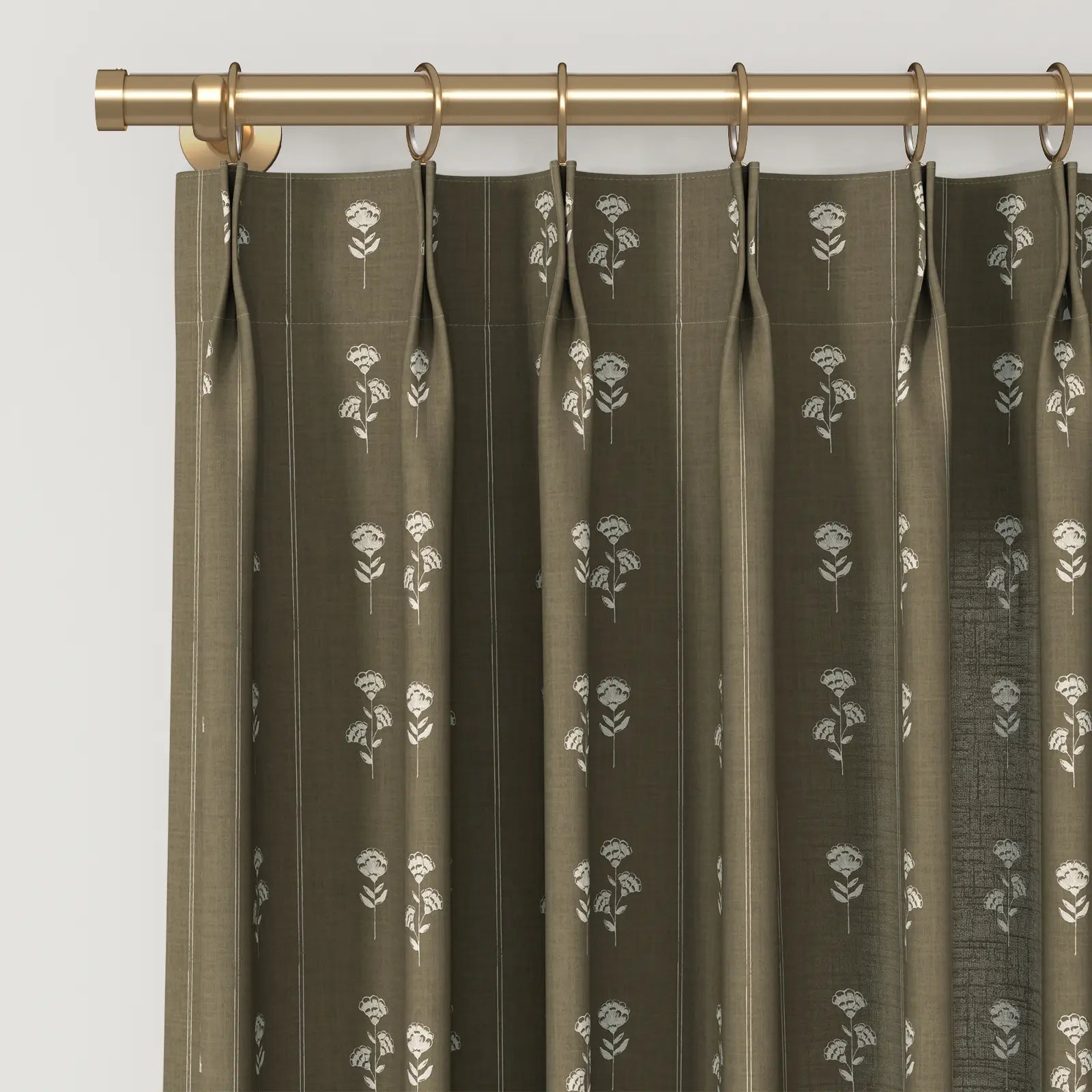 Olive green pinch pleat curtains with a repeating white stylized floral motif and subtle vertical pinstripes hanging from a polished gold curtain rod with matching rings