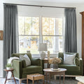 Dark Grey Liz linen curtains framing a bright window in a balanced full-length interior view