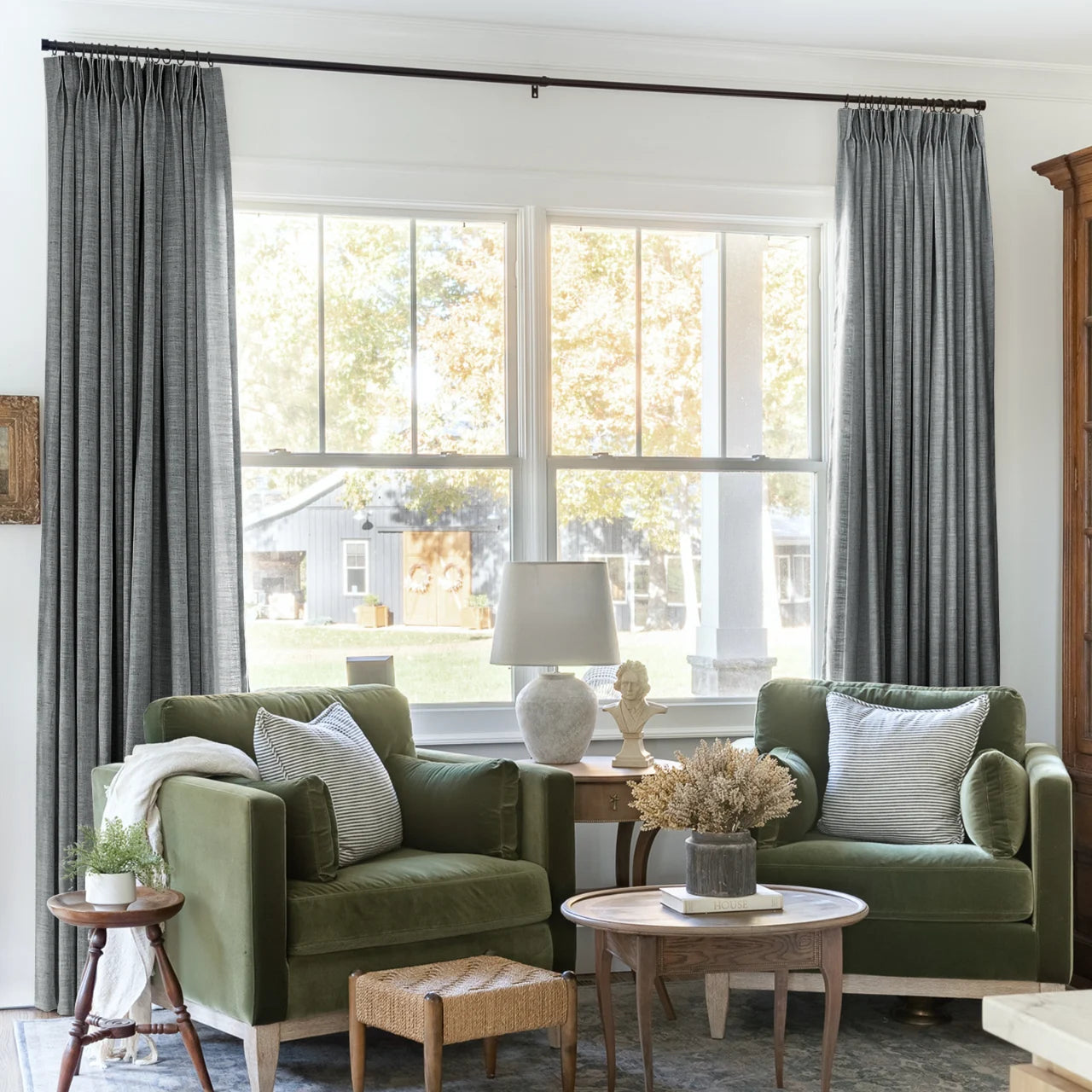 Dark Grey Liz linen curtains framing a bright window in a balanced full-length interior view