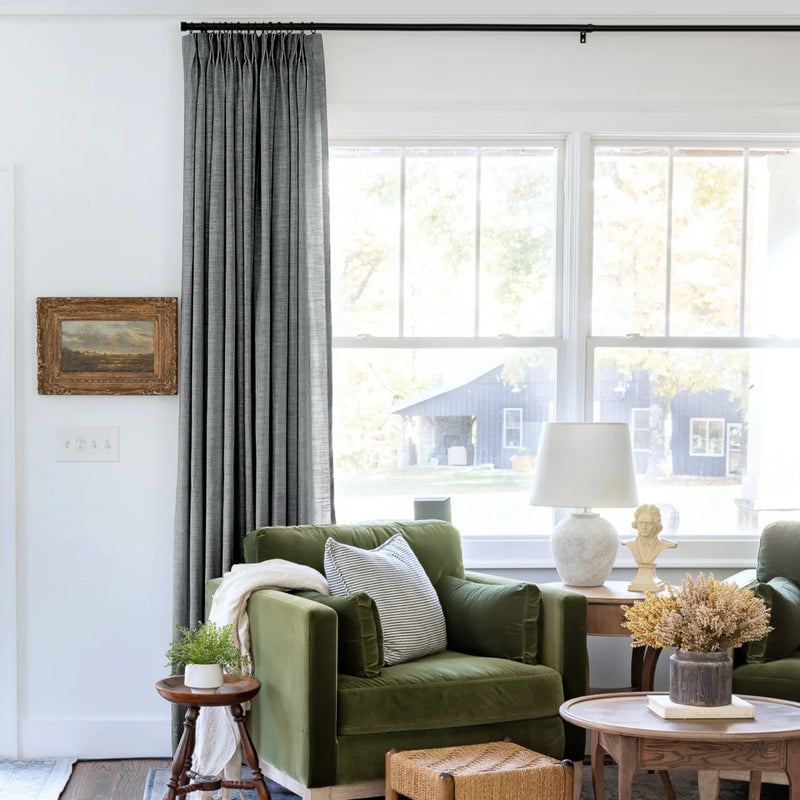Dark Grey Liz linen curtains shown closer beside a sunlit window with smooth vertical folds