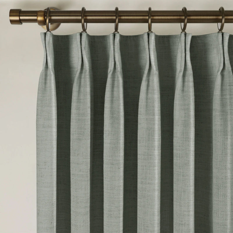 Dark Grey Liz linen curtains viewed at an angle in a softly styled room with natural daylight