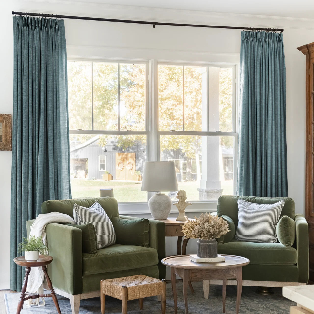 Everglade Teal Liz linen curtains framing a bright window in a balanced full-length interior view