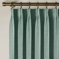 Everglade Teal Liz linen curtains viewed at an angle in a softly styled room with natural daylight