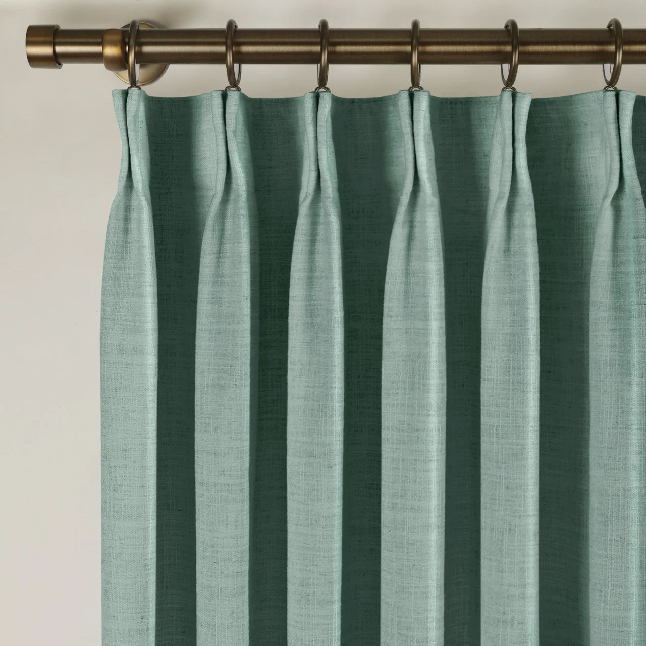 Everglade Teal Liz linen curtains viewed at an angle in a softly styled room with natural daylight