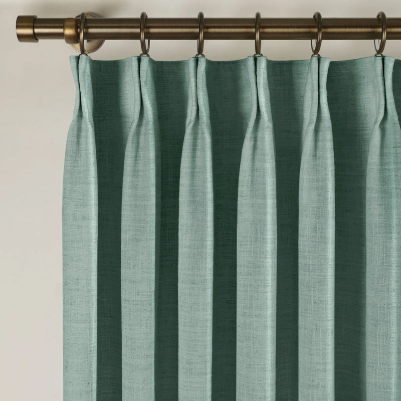 Everglade Teal Liz linen curtains viewed at an angle in a softly styled room with natural daylight