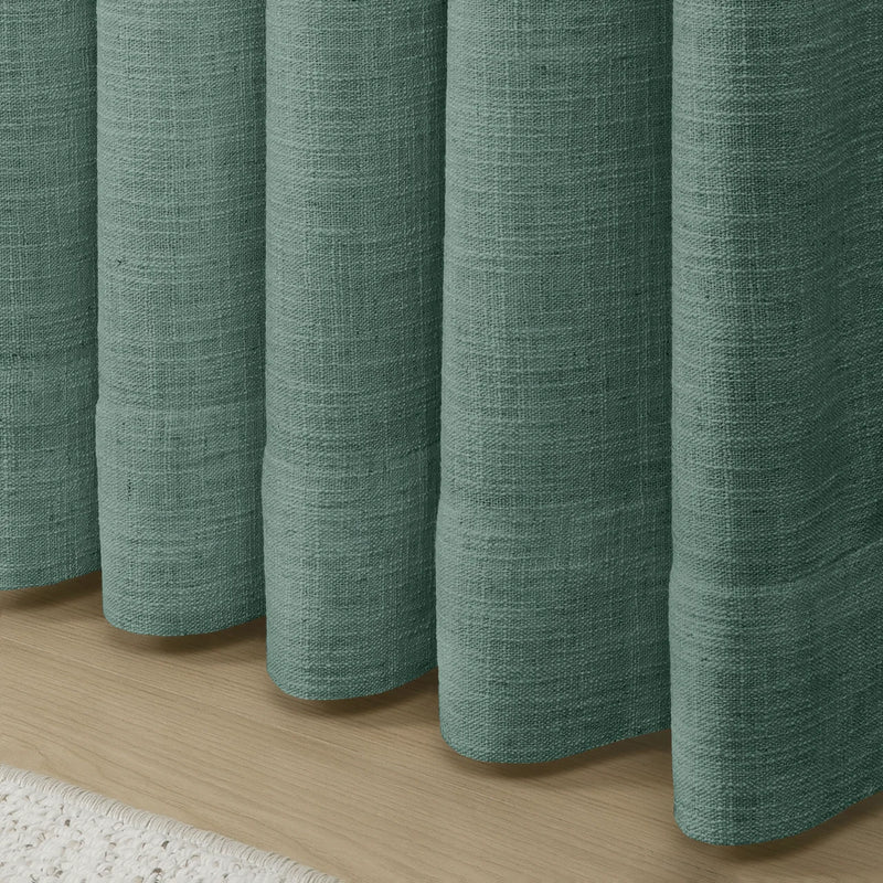Everglade Teal Liz linen curtains showing the lower drape and pooling folds near the floor
