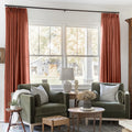 Firebrick Liz linen curtains framing a bright window in a balanced full-length interior view