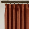 Firebrick Liz linen curtains viewed at an angle in a softly styled room with natural daylight