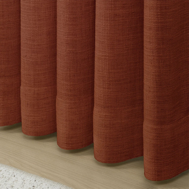 Firebrick Liz linen curtains showing the lower drape and pooling folds near the floor